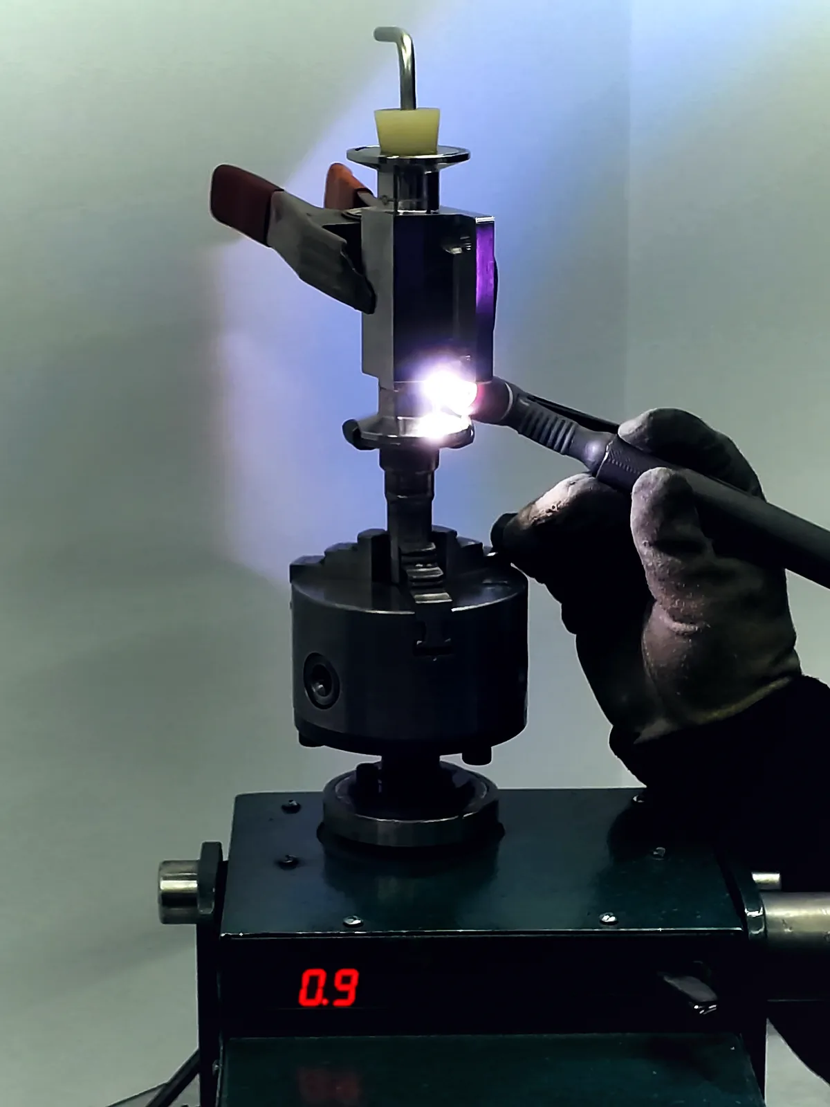 A hand TIG weld running on a valve body turned in a rotary weld positioner